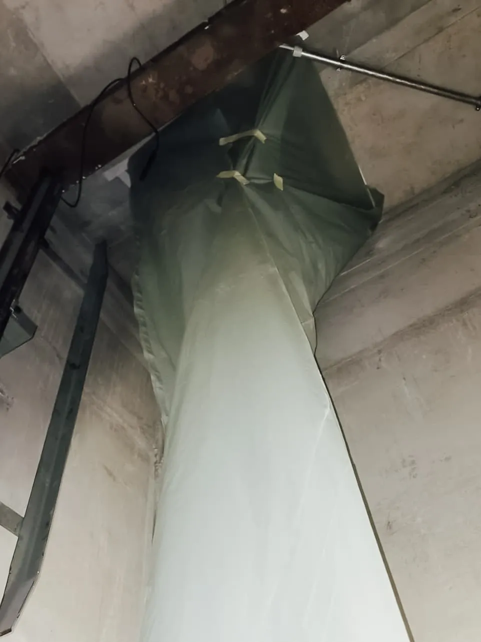 Durch eine Kernbohrung geführtes Rohr in einer Betonwand